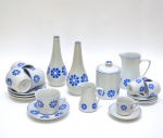 Aparelho de chá e café em porcelana da manufatura de `Porcelanart`. Fundo branco decorado por flores estilizadas em estampagem de tom azul. Composto de 2 solifleur (20 cm), leiteira (13 cm), açucareiro (12 cm), cremeira (9 cm), 4 xícaras de chá com pires (8 x 14 cm) e 4 xícaras de café (6 x 11 cm).
