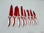 Jogo de 8 facas gourmet em aço inox na cor vermelha com suporte em acrílico.