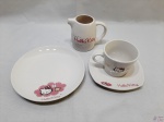 Jogo de xícara de chá com pires, prato de bolo e leiteira em porcelana da Hello Kitty.