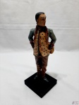 Escultura de homem com trajes típicos em resina com policromia. Medindo 26cm de altura.