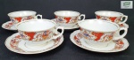 SCHMIDT - Cinco xícaras para chá com seus respectivos pires em porcelana esmaltada com vasos de flores e arabescos sobre fundo rouge de fer, realçadas com frisos dourados. 2 pires com bicados.