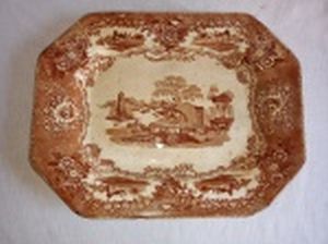 Travessa em faiança portuguesa, decoração estátua na tonalidade sépia. Marcada no fundo Massarellos Porto, Chambers & Wall. Cerca 1920. No estado, com lascados. 35,5 x 27,5cm.