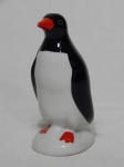 Escultura representando pinguim dito de geladeira em porcelana branca, preta e vermelha. Alt. 13cm.
