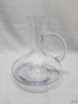Decanter bojudo de vinho incolor com alça. Medindo 12cm de altura x 19,5cm de diâmetro de bojo.