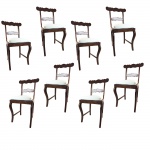 Oito cadeiras em jacarandá com estofamento em palhinha. Acompanham 8 almofadas forradas com seda branca tailandesa, cobertas por forro em algodão bege. Brasil, Séc. XIX. 90 x 42 x 47 cm.