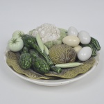 WEISS - Fruteira em faiança vitrificada nacional representando legumes e ovos em relevo. Policromada. Possui restauro.
