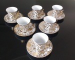 Jogo de xícaras de café em porcelana com detalhes em dourado, composto por 12 peças, seis pires e  seis xícaras.