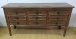 Buffet em madeira nobre patinada, comporta 9 gavetas no total, pés torneados, altura 98 x 53 x 186 cm.