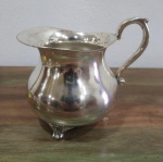 Leiteira em metal espessurado a prata com 12 cm de altura.