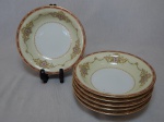 NORITAKE - Seis pratos fundos em porcelana japonesa, borda com esmaltagem bege, medalhões de buquê de flores circundado por volutas e acantos interligados por guirlandas, friso grená. Marcado no fundo. Diam. 19cm.