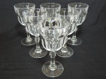 Seis taças em demi-cristal translúcido, pés em bolacha, lapidação dedão, haste facetada. Alt. 18cm.