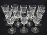 Doze taças para aperitivos em demi-cristal translúcido, pés em bolacha, lapidação dedão, haste facetada. Alt. 11cm.