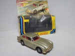 Réplica miniatura do automóvel Aston Martin DB5, popularizado como o carro de James Bond, da série de filmes 007, lançado em 1979 pela Corgi, escala 1:36, numeração 271, Reino Unido. Metal esmaltado. Acondicionado em embalagem original. Comp. 12cm.