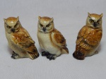 Três corujas decorativas em cerâmica vitrificada policromada. Alt. 8cm.
