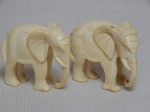 Dois elefantes africanos esculpidos em marfim. Alts. 4cm.