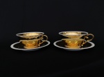 LIMOGES - Par de grandes xicaras em porcelana francesa  na cor creme pintada a ouro, alças vazadas, borda dos pires em gomos med 7x17cm