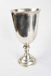 VASO PURIFICATÓRIO - MUITO GRANDE E IMPORTANTE VASO PURIFICATÓRIO EM PRATA DE LEI BATIDA. ESTRUTURA DESMONTÁVEL COMO DEVE SER NA DOS BONS VASOS SETECENTISTAS. IMPRESSIONANTE PELA GRANDE DIMENSÃO. PODE-SE OBSERVAR O BELISSIMO TRABALHO BATIDO NA PRATA TANTO NA PARTE INFERIOR DA BASE, QUANTO NA PARTE INTERNA DO COPO. O FUSTE É HARMONICAMENTE EXECUTADO COM FEITIO DE BALAÚSTRE. PEÇA DIGNA DE MUSEU, CERTAMENTE PERTENCEU A GRANDE IGREJA PAROQUIAL. BRASIL, MEADOS DO SEC. XVIII. 29,5 CM DE ALTURA X 14 CM DE DIAMETRO. 810G.NOTA: Esse elemento de Alfaia era empregado no ritual litúrgico de purificação nas missas até meados do sec. XIX. Esse vaso ou grande cálice representava o símbolo da purificação. Os vasos eram grandes, bojudos, mas seu fuste não poderia ser mais elevado do que os cálices do vinho da eucaristia da missa nem poderiam ser de ouro ou prata dourada. Antes da comunhão o Acólito levava o vaso até os fiéis contendo água e coberto por um pano de linho feito especialmente para esse fim. A água era o elemento da purificação. Antes de receber o corpo do Senhor, cada fiel levava o cálice à boca, depois que tomava a água o Acólito passava o pano de linho na borda do vaso e o oferecia ao próximo fiel. Por volta de 1850 esse ritual foi eliminado da liturgia da missa para evitar a propagação de doenças. Por terem sido abolidos há cerca de 150 anos esses vasos são extremamente raros constituindo-se verdadeiras peças de museu e alto colecionismo.