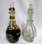 Duas garrafas de licor Frances SECRESTAT . uma com conteúdo ( CARMELINE,,PAUNELLE, TRIPLE ORANGE  E CHERRY ) com duas rolhas de vidro. A outra completa , mas sem conteúdo. Ambas com 4 divisórias internas com separação dos sabores e tampas individuais. Conteúdo sem garantia de validade. Altura 32 cm com tampas.