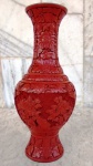 Vaso em metal com aplicação de técnica de laca vermelha , decorado com elementos fitomorfos , semelhante a vegetações . Altura 26 cm .