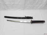Katana decorativa com lâmina em aço sem fio, punho revestido com tecido e acabamento em metal e bainha em resina. Medindo 69cm de comprimento sem bainha e 79cm de comprimento com bainha.