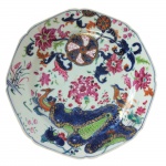 Prato raso para jantar em porcelana policromada Cia. das Índias, decoração folha de chá. China. Qing, Qianlong (1736-1795), Séc. XVIII. 22,5 cm de diâmetro. (Devido a fragilidade desse lote, seu envio só será realizado através de transportadora especializada). Chama-se Companhia das Índias a porcelana produzida na China por encomenda e com formas ou decoração ao gosto ocidental, transportada pelos navios das diversas Companhias das Índias - inglesa, francesa, holandesa, sueca etc. -, ativas entre os Sécs. XVII e começos do XIX. Nas porcelanas policromadas, ocorrem dois tipos principais de decoração: a Família Verde, surgida em fins do Séc. XVII sob o reinado do Imperador Kangxi (falecido em 1722), e a Família Rosa, caracterizada pela utilização de um esmalte de cor rósea, surgida mais ou menos em 1720 e que se estenderia por todo o reinado do Imperador Qianlong (1736-1795). Flores, pássaros e figuras humanas constituem a decoração preponderante nessas porcelanas. Além desses dois, existem, porém, outros tipos de decoração policromada, como por exemplo a Família Negra, que consiste na esmaltagem sobre fundo negro; a Café com Leite, na cor castanha, também chamada porcelana de Batávia porque era exportada através do porto de Batávia, em Java; e o Imari chinês, cuja decoração imita as porcelanas japonesas produzidas em Arita, na província de Hizen. Inúmeros serviços de jantar ou de chá e café em porcelana Companhia das Índias foram encomendados por nobres ingleses, franceses, alemães, holandeses, portugueses etc. e exibem suas armas ou brasões. De notar que os portugueses foram os primeiros europeus a encomendar à China peças de porcelana exibindo suas armas, sendo que as mais antigas remontam ao reinado do Imperador Zhengde (1506-1521), da Dinastia Ming.