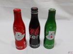 Jogo de 3 garrafas promocionais da Coca-Cola em alumínio. Medindo 18,5cm de altura. Sendo 2 delas lacradas.