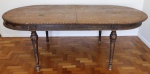 MOBILIÁRIO - Mesa de jantar oval em madeira nobre, pés torneados, barra com entalhes e detalhes floral. Med.  78x220x110 cm. Marcas do tempo, uso e desgastes.