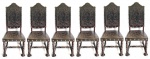 MOBILIARIO - Lote de 6 antigas cadeiras em madeira nobre, no estilo Manuelino. Assento e encosto em couro pirogravado e tacheado. Pés unidos por trave central. Uma com couro no estado. Med. 116x48x43 cm.