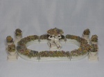 CAPODIMONTE - Grupo escultórico em porcelana italiana branca aplicado com delicadas flores policromadas, representando jardim, composto por 13 peças montáveis. Marcado no fundo. Pequenos lascados nas flores. Total 9 x 30 x 19cm