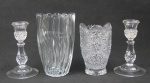 a) Dois vasos, sendo 1 em demi cristal lapidado com sulcos e gomos ondulados e o outro em cristal com lapidações de rosetas, sulcos e dedão. Alt. 19,5 e 16 cm.b) Par de castiçais em cristal translucido, com lapidações bico de jaca e dedão. Alts. 17 cm.