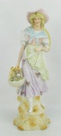 Estatueta em biscuit europeu, policromada, representando "Jovem Florista". Detalhes esmaltados. Alt. 27,5cm.
