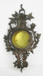 Caixa para relógio de parede em bronze, profusamente trabalhado com folhagens, flores e volutas. Detalhes vazados. Med. 51,5x29x5,5 cm.