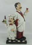 Grupo escultórico em material sintético policromado, representando "Garçons". Alt. 37 cm.