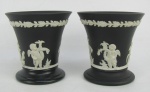 Par de pequenos vasos em biscuit inglês no tom preto, com marca da manufatura Wedgwood na base. Decorados com figuras orientais e folhagens em relevo. Marcados, numerados e localizados england a crivo na base. Alt. 8cm.