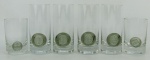 Seis copos em vidro alemão translúcido, da manufatura Rosenthal, decorados com trabalhos em relevo no tom fumê. Apresenta marca R coroado na base. Um não apresenta marca. Alts. 14,5cm (4) e 10,5cm (2).
