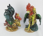 E.H. - Par de estatuetas em cerâmica policromada, representando "Casal de galos". Marca da manufatura na base e assinados com monograma. Com restauro. Als. 27 e 24cm.