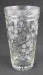 Vaso em grosso cristal translúcido, decorado com lapidações de flores, folhas, sulcos, frisos, facetados e bico de jaca. Alt. 30cm.