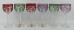Seis taças em demi cristal alemão, tendo três etiqueta da Cristallerie Anna Hutte Bleikristall, sendo pintadas duas de cada cor. Lapidações dedão, abacaxis e folhagens bisotados, e flores em satiné. Alt. 18cm.