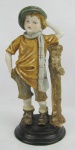 Estatueta em biscuit europeu policromado com marca da manufatura na base, representando "Menino". Alt. 28cm.