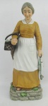 Estatueta em biscuit europeu, policromada, representando "Vendedora de Peixes". Alt. 32cm.