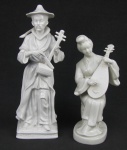 Duas estatuetas em porcelana oriental, representando "Músico" e "Musicista". Alts. 27,5 e 21,5cm.
