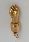 Figa em ouro 18k. Alt. com argola 2,5cm. Peso 0,8g. Este ítem não se encontra no local do leilão.