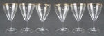 Seis taças em fino cristal translúcido, decoradas com detalhes em dourado na borda, tendo estes desgastes causados pelo tempo. Alt. 16,5cm.