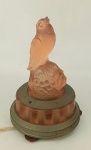 Rara luminária art-deco, em vidro satiné no tom salmão, na forma de pássaro sobre folhas e frutas. Guarnições em metal. Funcionando. Alt. 22cm.