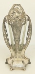 WMF - Floreira alemã com marca da manufatura em metal espessurado a prata, com decoração art-noveau, com alças vazadas, figuras femininas, folhagens, frutos e arabescos. Vidro adaptado e pequenas perdas no prateado. Alt. 34cm.