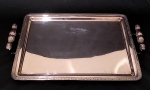CRISTOFOLI - Bandeja em metal espessurado a prata com alças trabalhadas e detalhes em alto relevo nas bordas. Medidas com alças 48 x 32 cm.