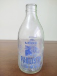 Garrafa de Vidro do leite Paulista sendo de 1 litro, medindo 22 cm de altura