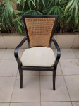 Cadeira com braços em madeira escura com encosto em palhinha trançada e assento de plástico trançado, acompanha almofada. Medindo 57cm de largura x 47cm de profundidade x 99cm de altura do encosto.