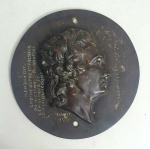 Medalhão em bronze perfil de Pierre-Jean David d'Angers, foi ele o mais prolífico e um dos escultores franceses mais importantes da primeira metade do século XIX.Ao longo de sua carreira de quase cinquenta anos (18191856), David permaneceu fiel à sua convicção de que os monumentos escultóricos dedicados às realizações de grandes homens e mulheres expressam de forma mais permanente e vívida a grandeza de um povo.Ele continuamente buscou encomendas de monumentos retratando figuras históricas e contemporâneas que ele admirava, a fim de enviar suas contribuições para a posteridade.Sua encomenda pública mais famosa, o frontão figurativo do Panteão de Paris (1830-1837), que homenageia grandes homens e foi dedicado por uma nação agradecida, exemplifica esses princípios ao longo da vida.David d'Angers estendeu sua definição de monumentos públicos para incluir medalhões de retratos.Na década de 1820, ele se dedicou a uma campanha pessoal de criação de retratos medalhões contemporâneos e retrospectivos de modelos ilustres.No final de sua vida, David executou quase quinhentos medalhões de retratos, frequentemente viajando grandes distâncias para modelar seus modelos de vida.
