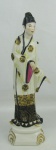 Estatueta art-deco, de coleção, em porcelana europeia, policromada, representando "Gueixa". Assinada com monograma no verso. Alt. 31 cm.
